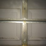 One piece garage door with two long metal rods